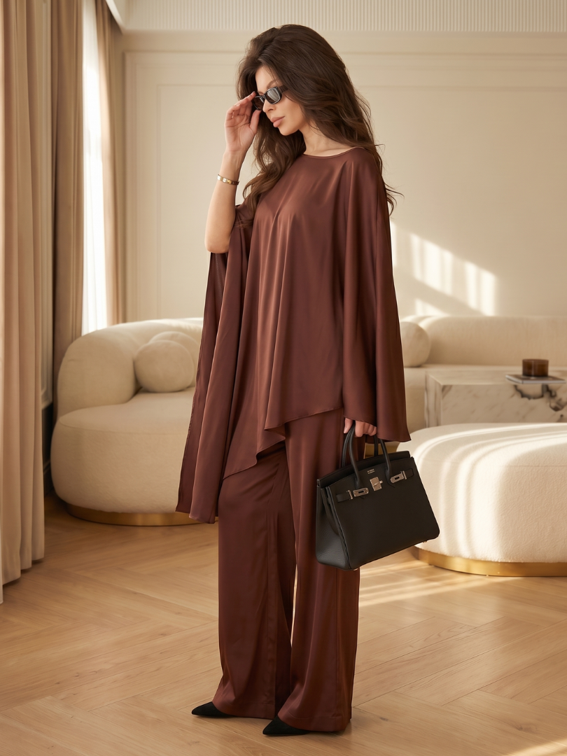 Brown asymmetrical two-piece set, draped top with wide-leg pants, side view