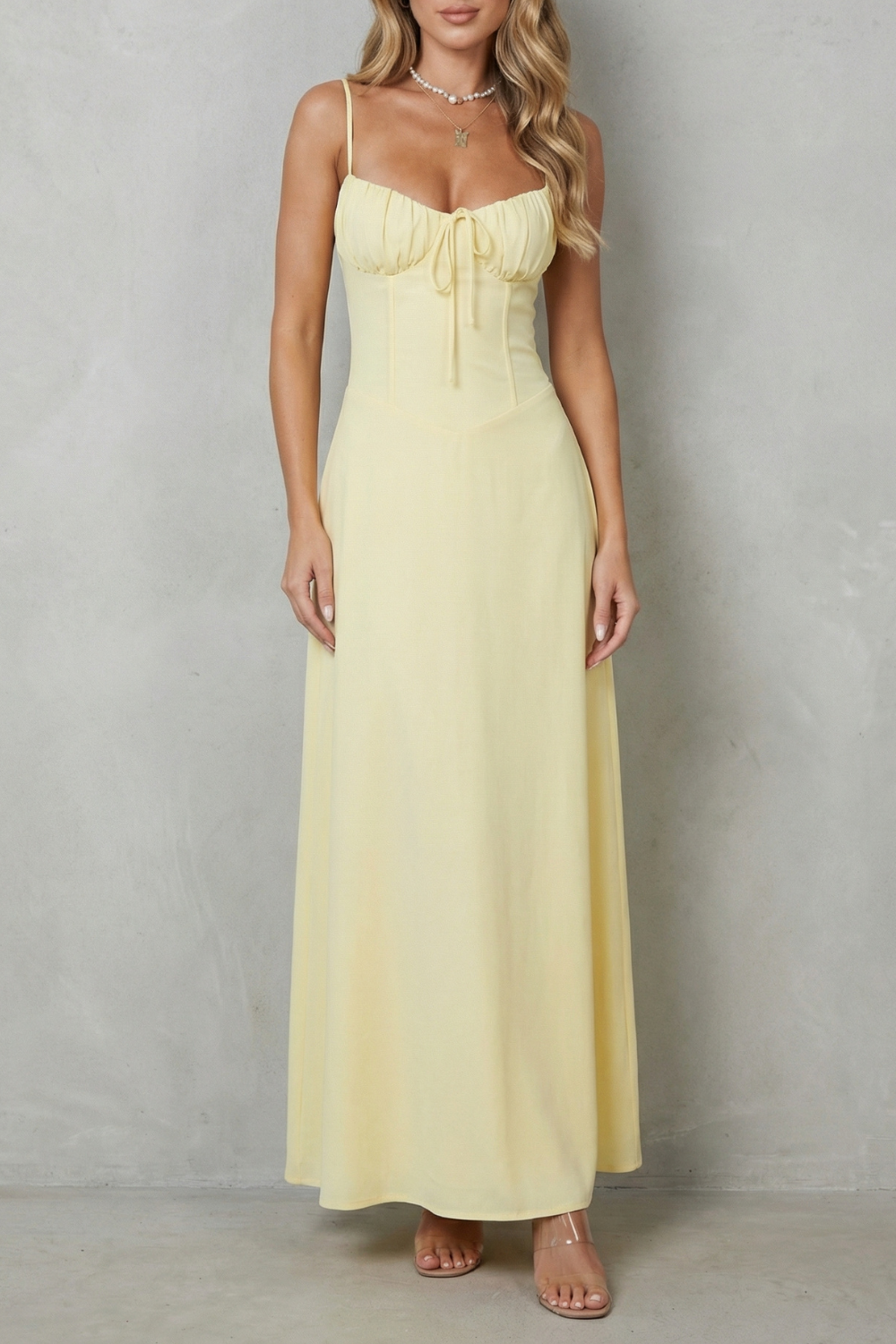 Yellow corset maxi dress with spaghetti straps and ruched sweetheart neckline tie detail