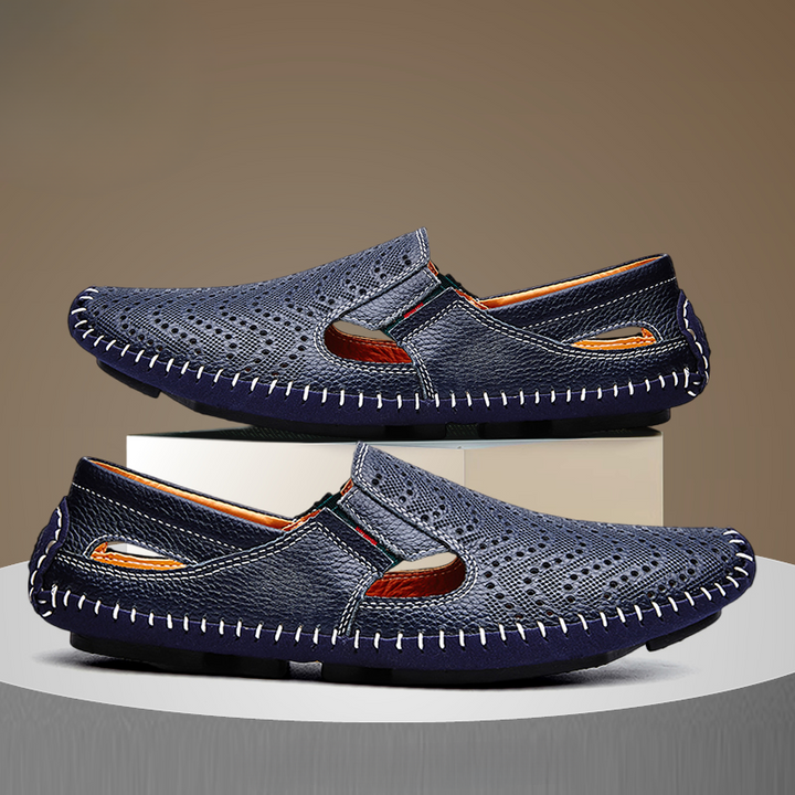 Navy slip-on sandals, perforated upper and moc-style cutout, contrast stitching