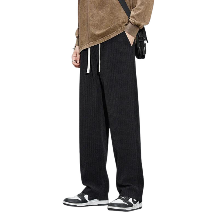 Black Roman velvet pants with elastic waistband and drawstring ties, relaxed wide-leg fit.