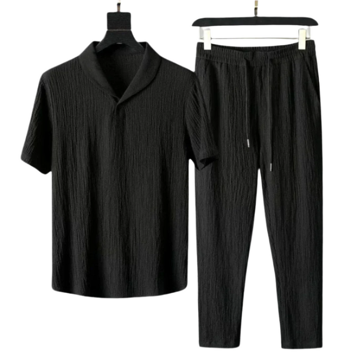 Black cotton polo shirt with short sleeves and black pants set with elastic waist.