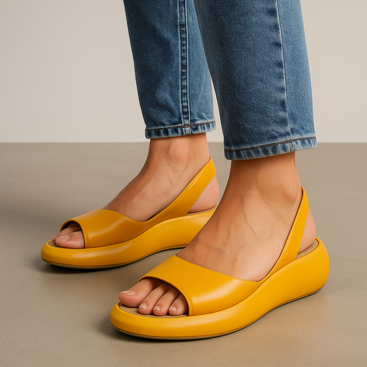 Orthopedic open-toe sandals, yellow slip-on with wide strap and low cushioned platform.