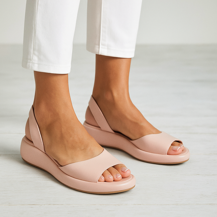 Orthopedic open-toe sandals, blush pink slip-on with wide strap and cushioned sole.