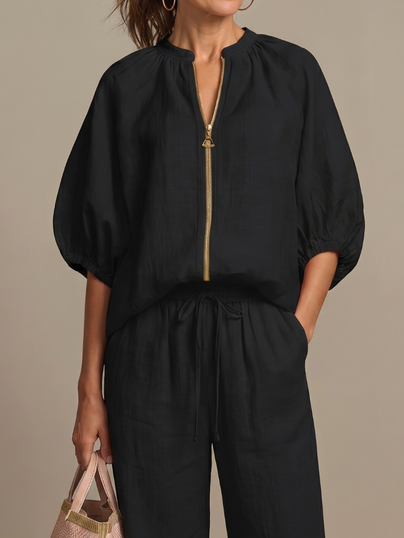 Women’s wide-leg pants set: black blouse with gold zipper and puff sleeves, matching trousers