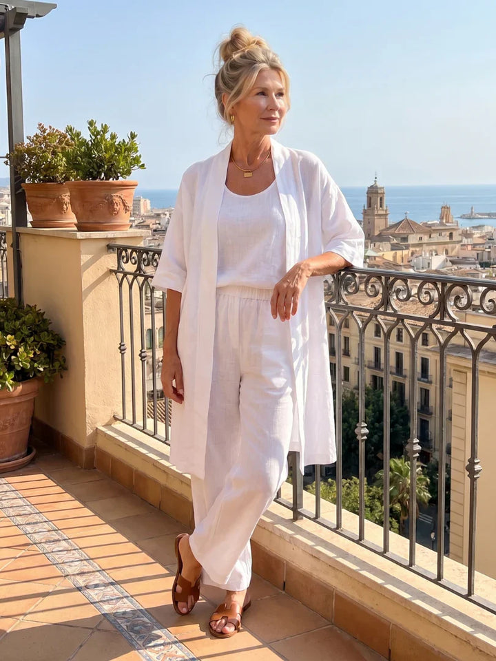 White lounge set with short-sleeve top, elastic-waist pants, and long open duster layer