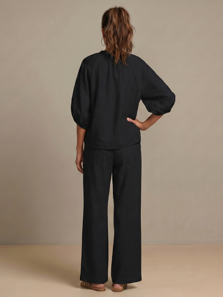Women’s wide-leg pants set: black puff-sleeve blouse and wide-leg trousers, back view