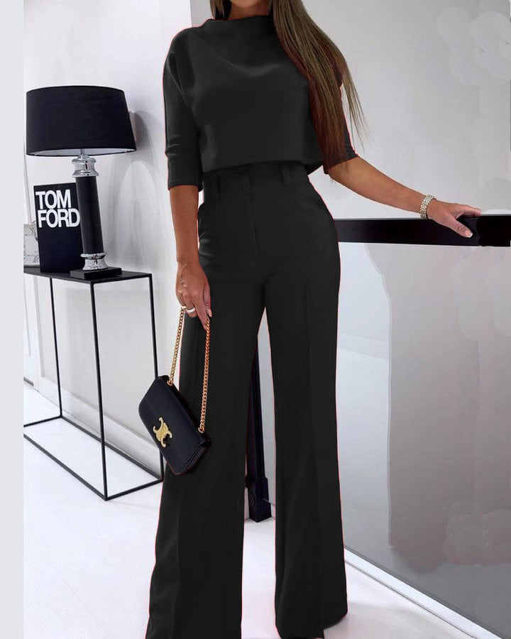 Black layered two-piece set with elbow-sleeve cropped top and high-rise wide-leg pants