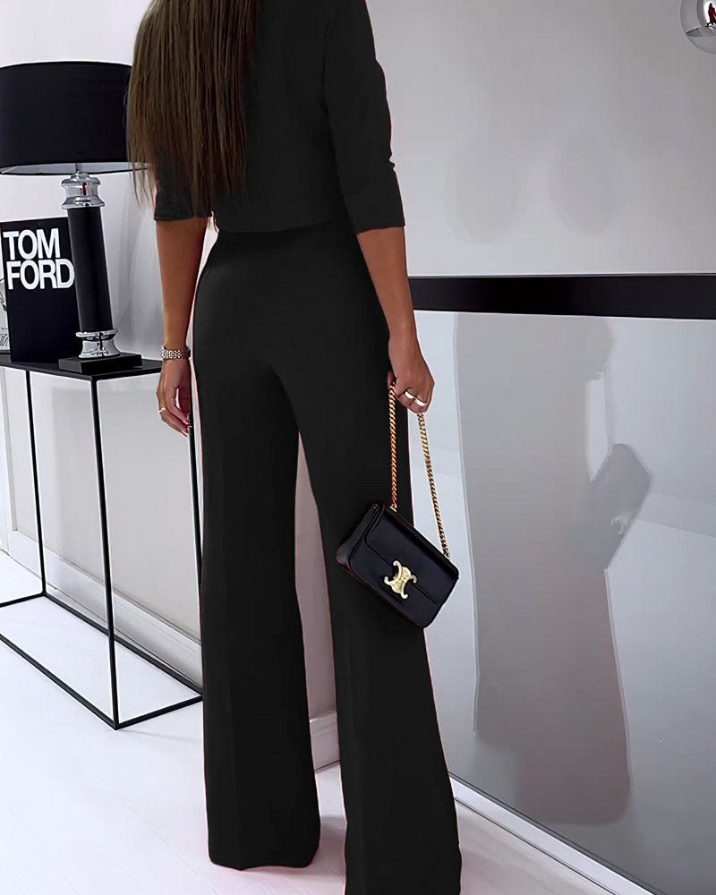 Black layered two-piece set with cropped top and high-rise wide-leg pants, side view
