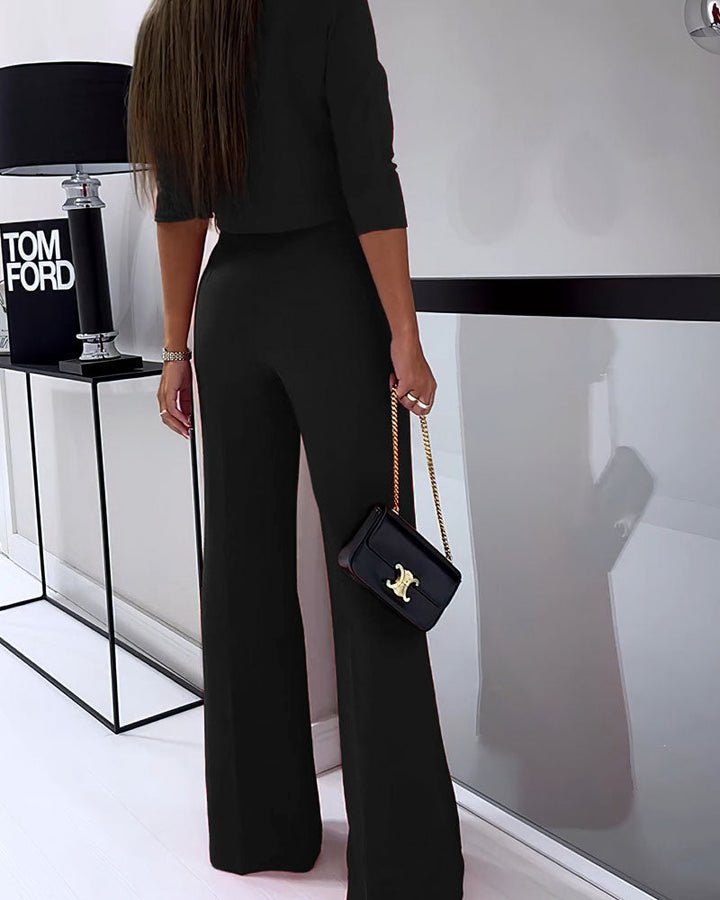Black layered two-piece set with cropped top and high-rise wide-leg pants, side view