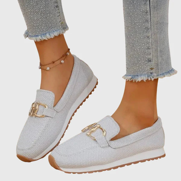 White women's comfort slip-on loafers with gold buckle and low-profile cushioned sole