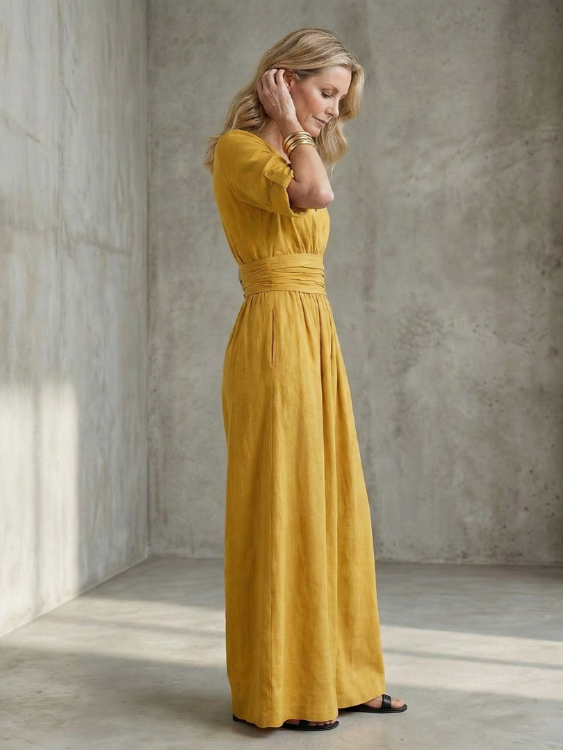 Yellow wide-leg wrap jumpsuit, back view with gathered waist and three-quarter sleeves