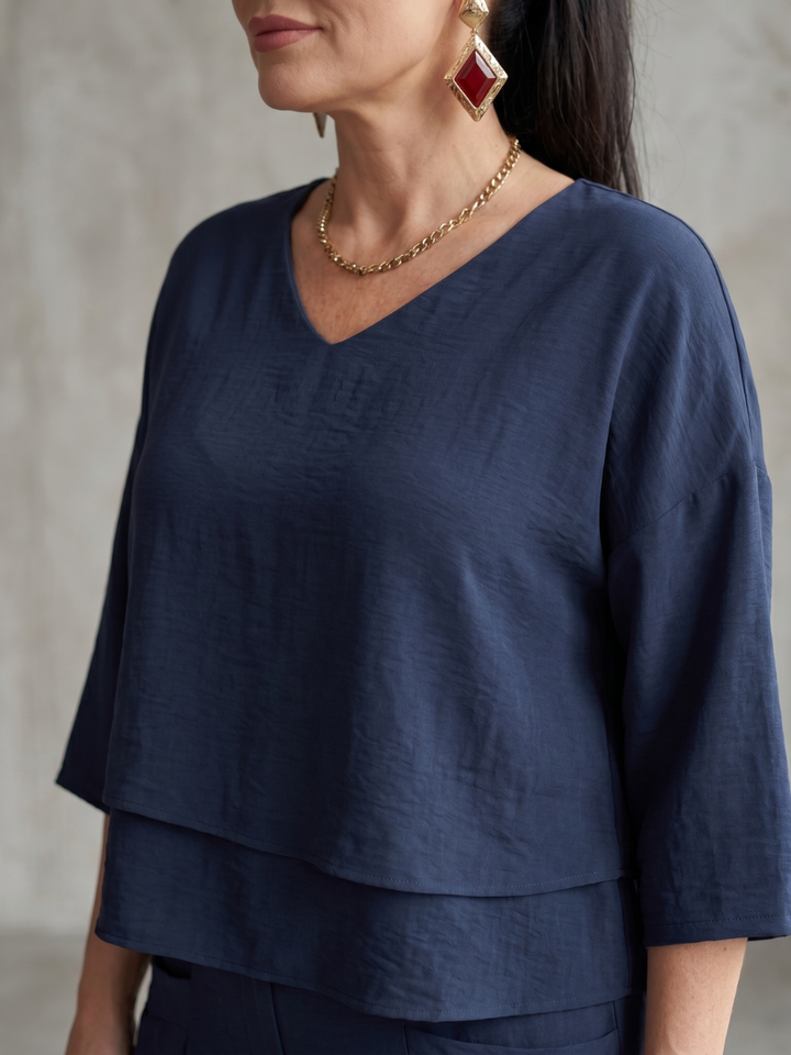 Navy wide-leg pants set top with V-neck and elbow-length sleeves, tiered hem.