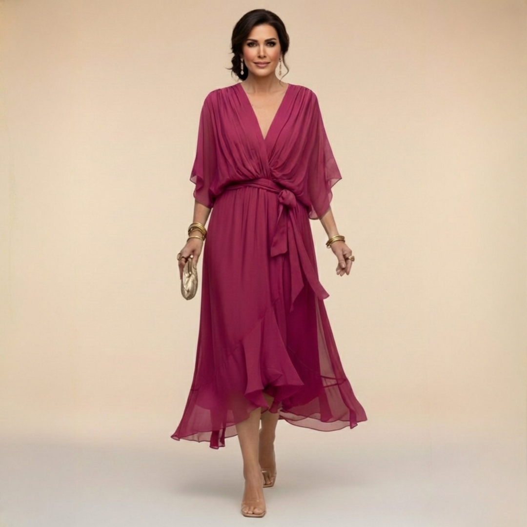 Purple V-neck wrap dress with tied waist and sheer, flowing chiffon midi skirt