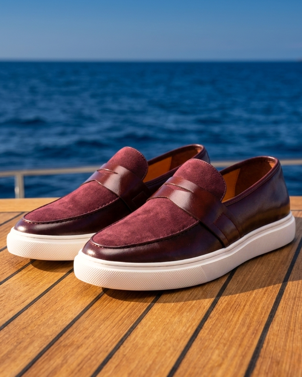 Pair of burgundy leather loafers slip-on with strap detail and white sole