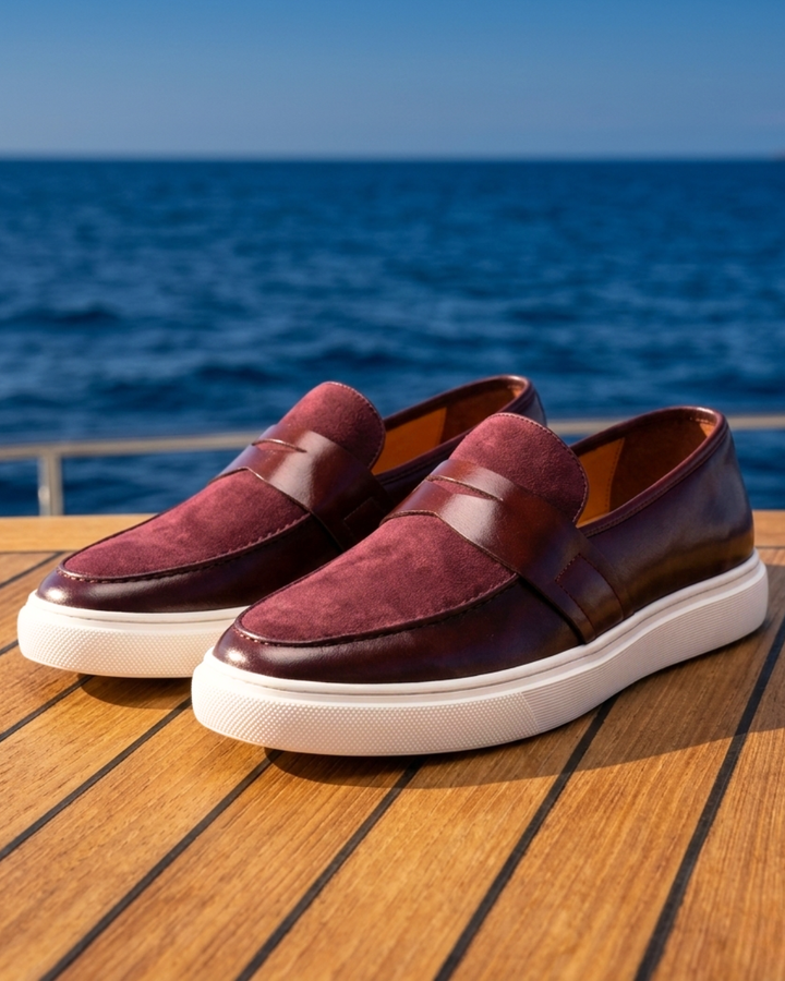 Pair of burgundy leather loafers slip-on with strap detail and white sole
