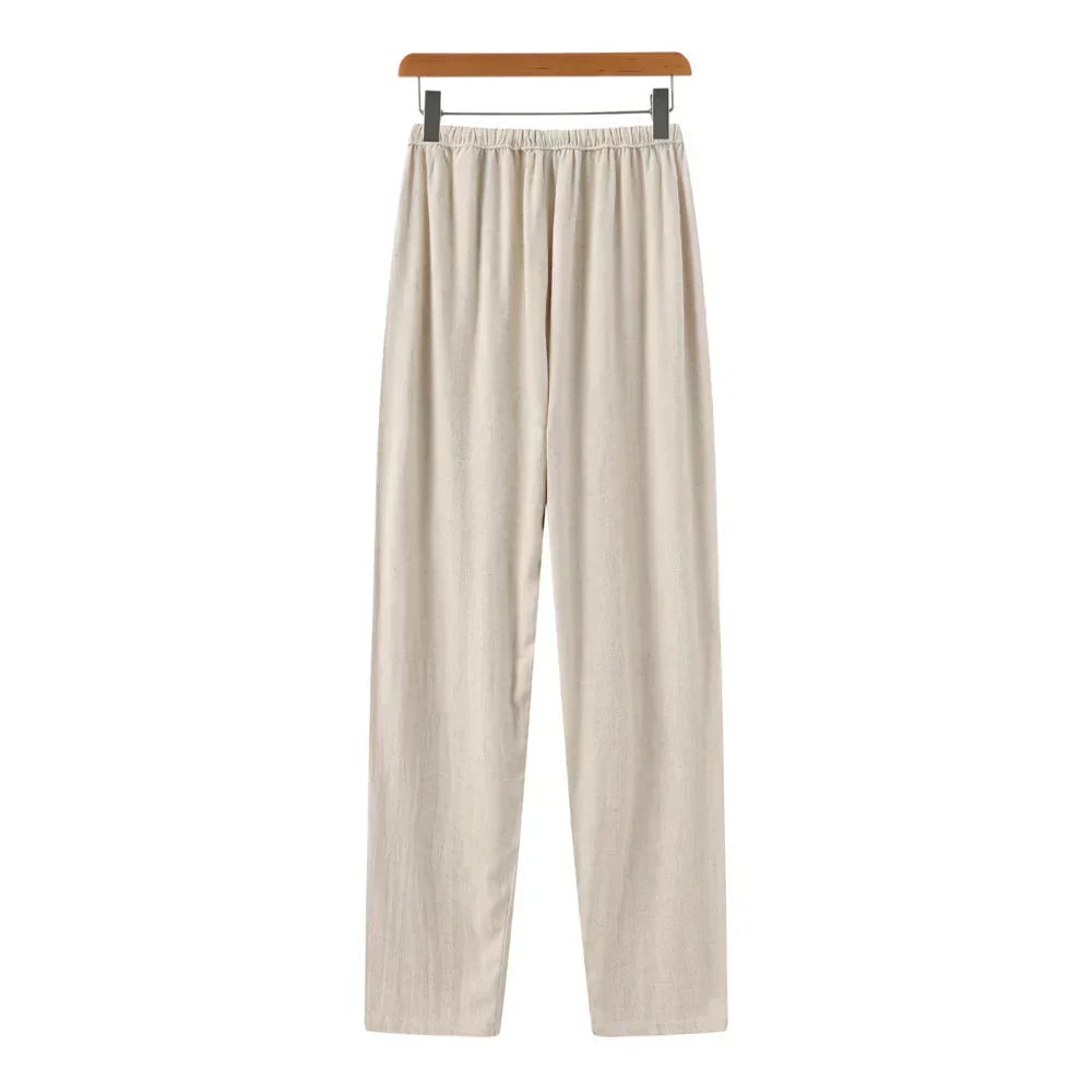 Beige linen pants with gathered elastic waist and vertical pleats down the front.