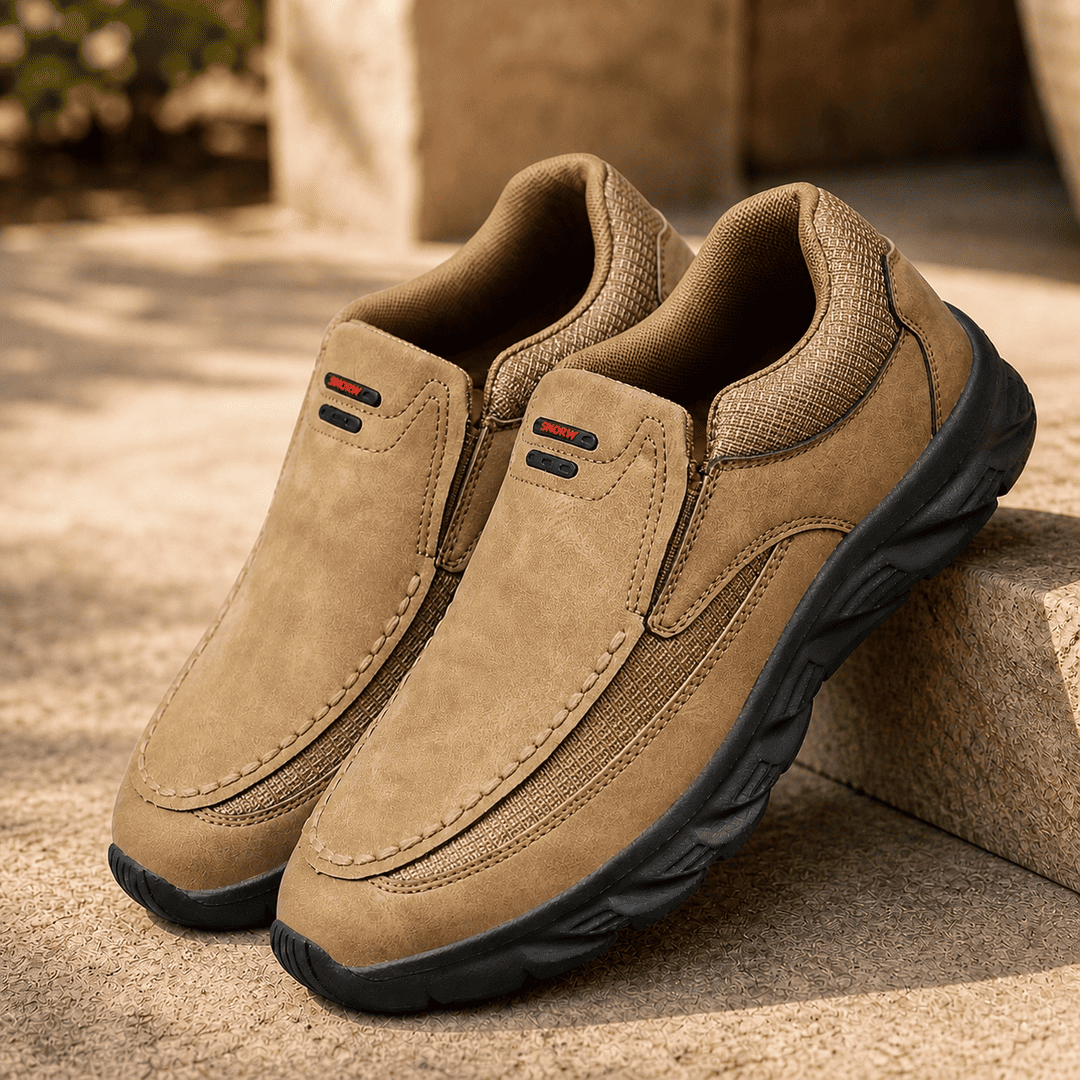 Light brown suede slip-on comfort shoes with black treaded sole and side pull tabs