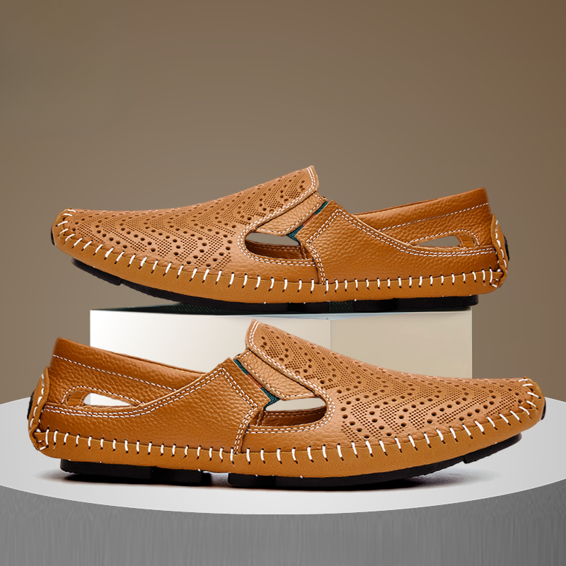 Tan moc-style slip-on sandals with perforated panels and contrast stitched sole