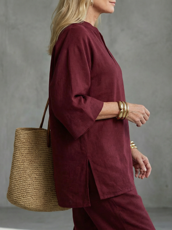 Burgundy women’s V-neck tunic top and matching pants, close-up side view