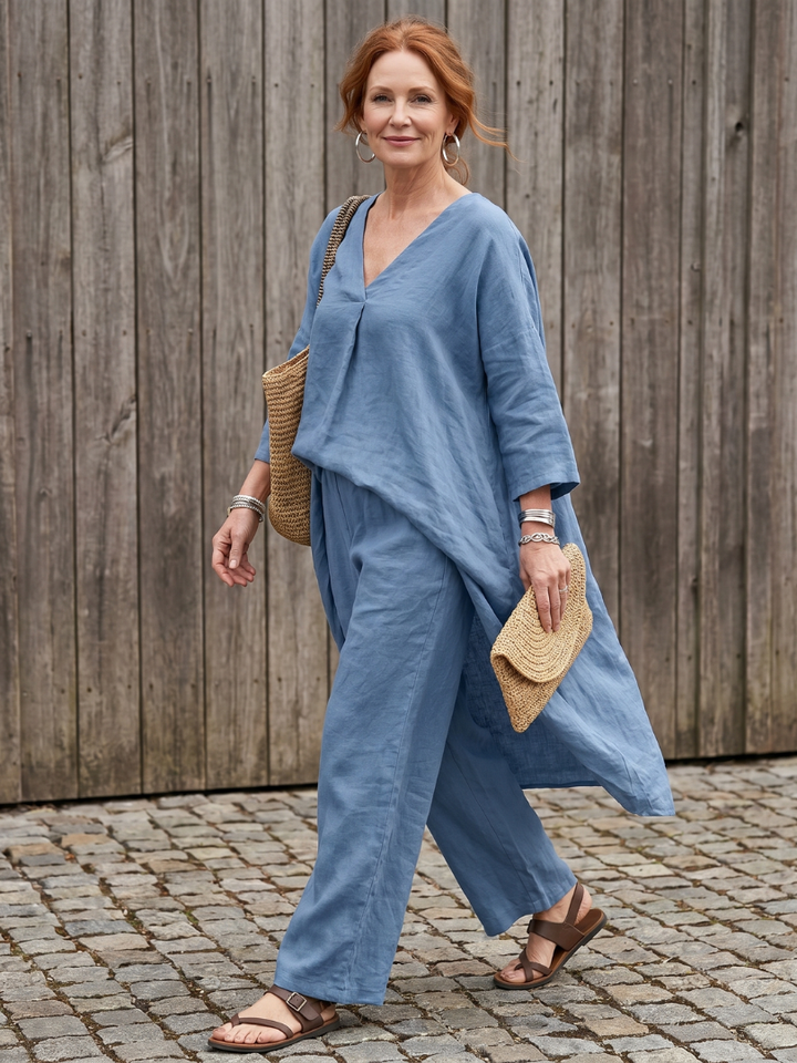 Blue linen two-piece set with V-neck tunic top and wide-leg pants, side view.