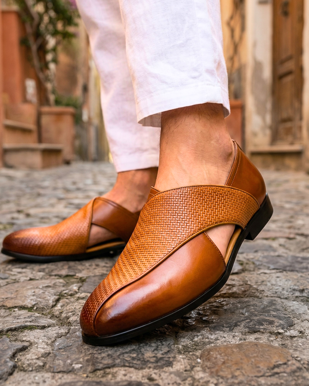 Brown slip-on loafers with woven upper, leather vamp, and black outsole
