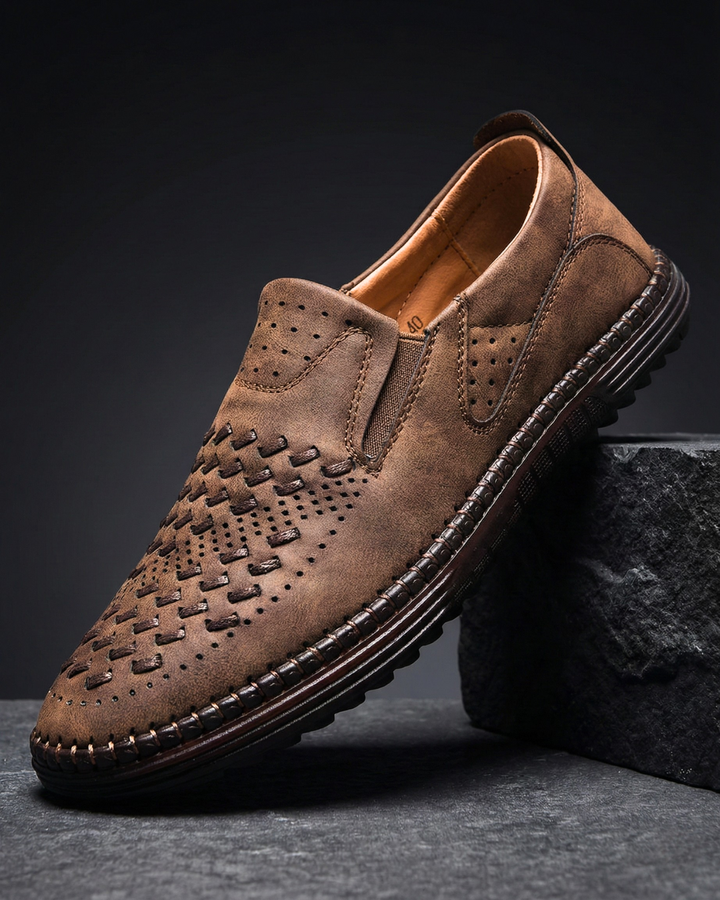 Brown leather loafer with perforated moc-toe pattern and side slip-on panel