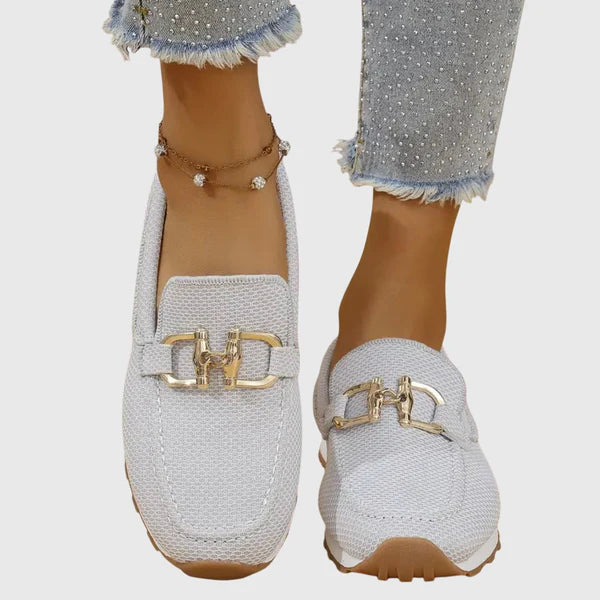 White women's comfort slip-on loafers with gold buckle ornament and rubber sole