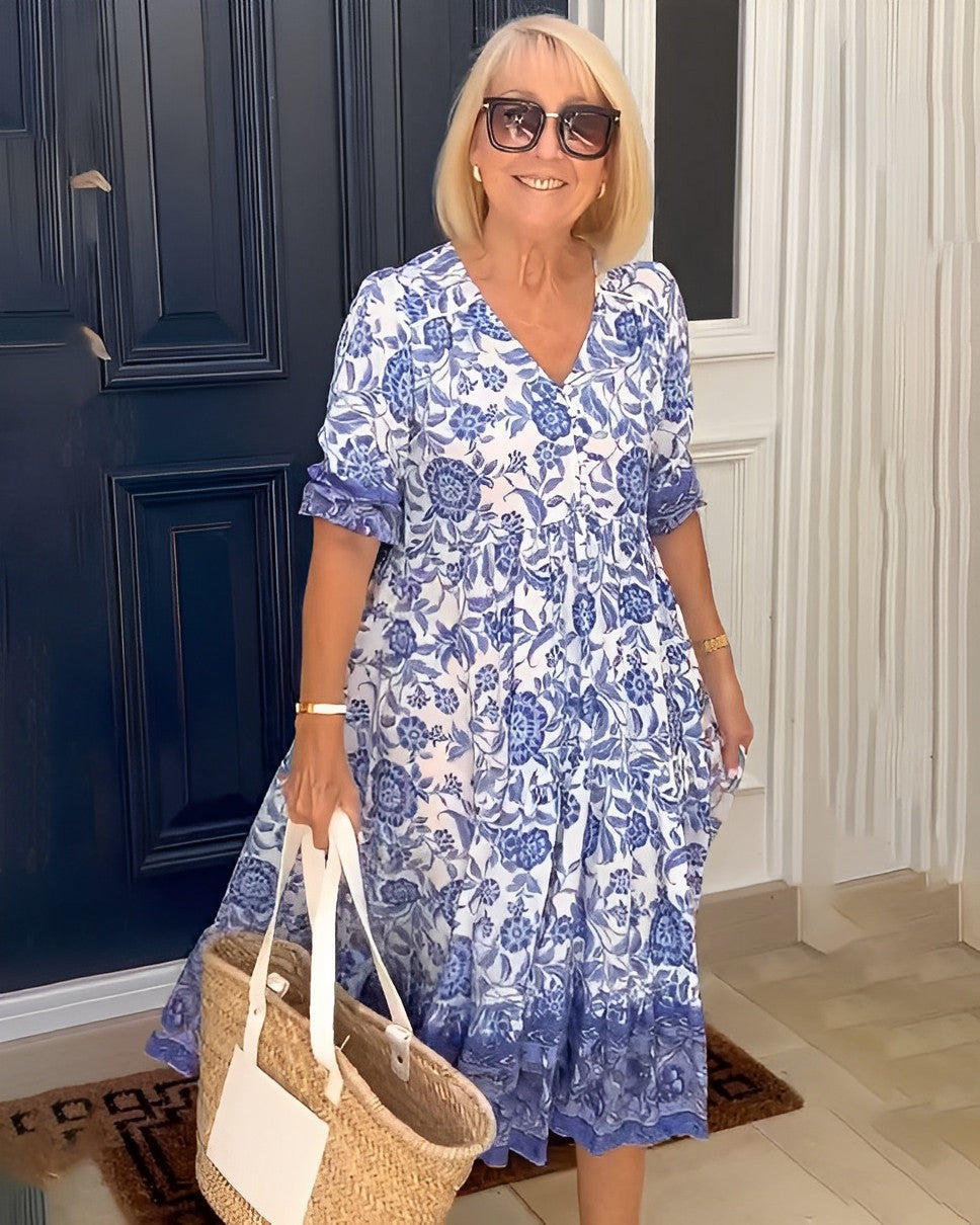 Blue floral V-neck midi dress with short sleeves and layered ruffle skirt hem