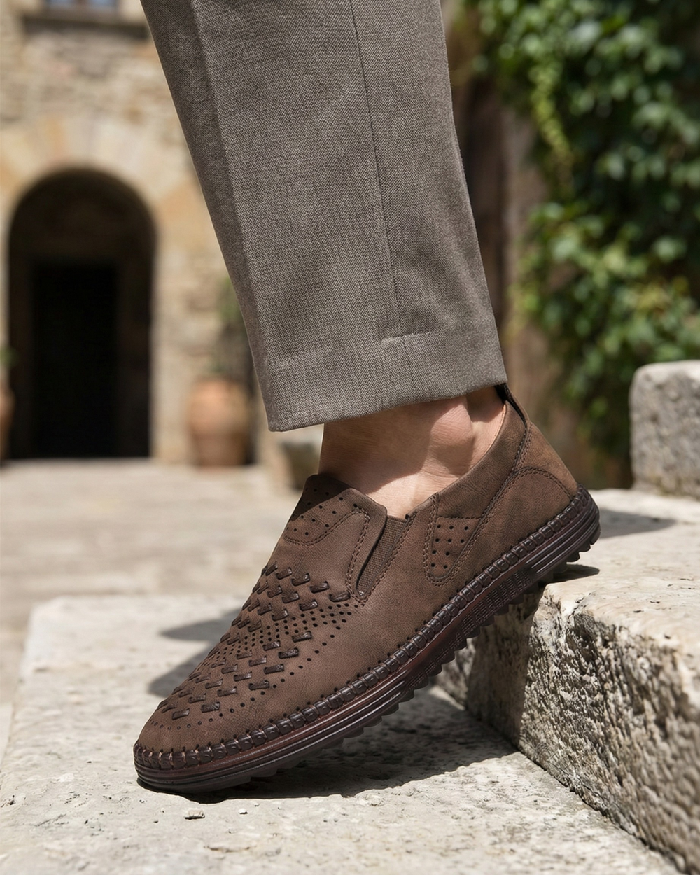 Brown perforated leather loafer with slip-on top and stitched edge sole