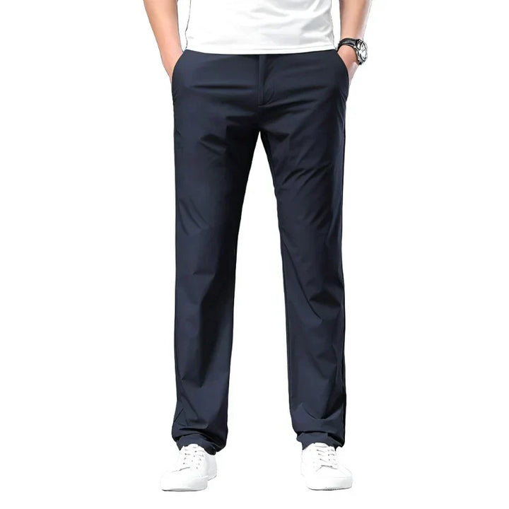 Navy chino pants with belt loops, slant front pockets, and tapered fit.