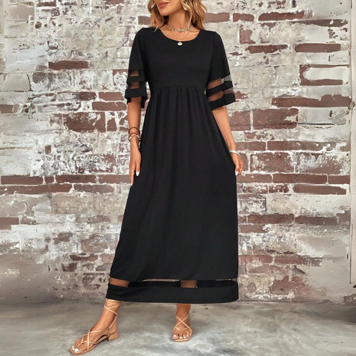 Black midi dress with gathered waist, scoop neck, sheer cutout sleeves, and mesh hem panel.