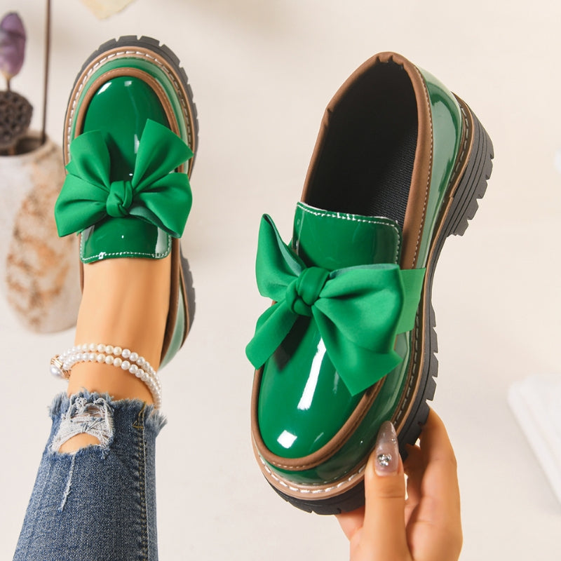 Green slip-on loafers with oversized bow and chunky tread sole