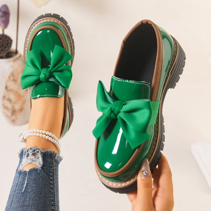 Green slip-on loafers with oversized bow and chunky tread sole