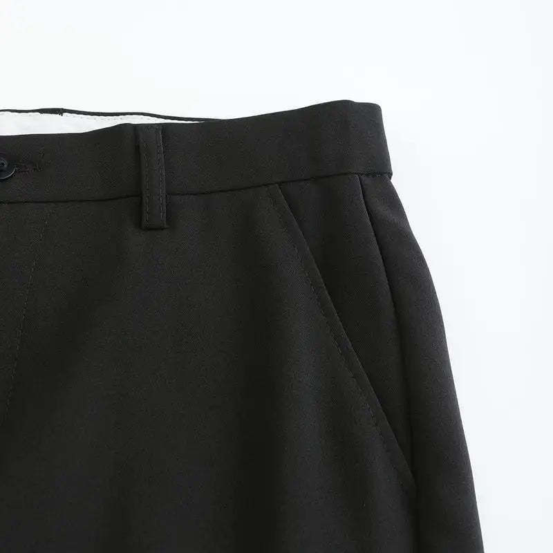 Black stretch pants front pleat and waistband close-up