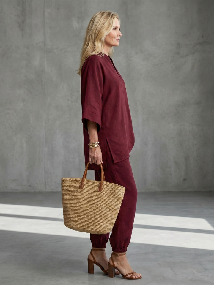 Burgundy women’s V-neck two-piece set with tunic top and relaxed jogger-style pants, side