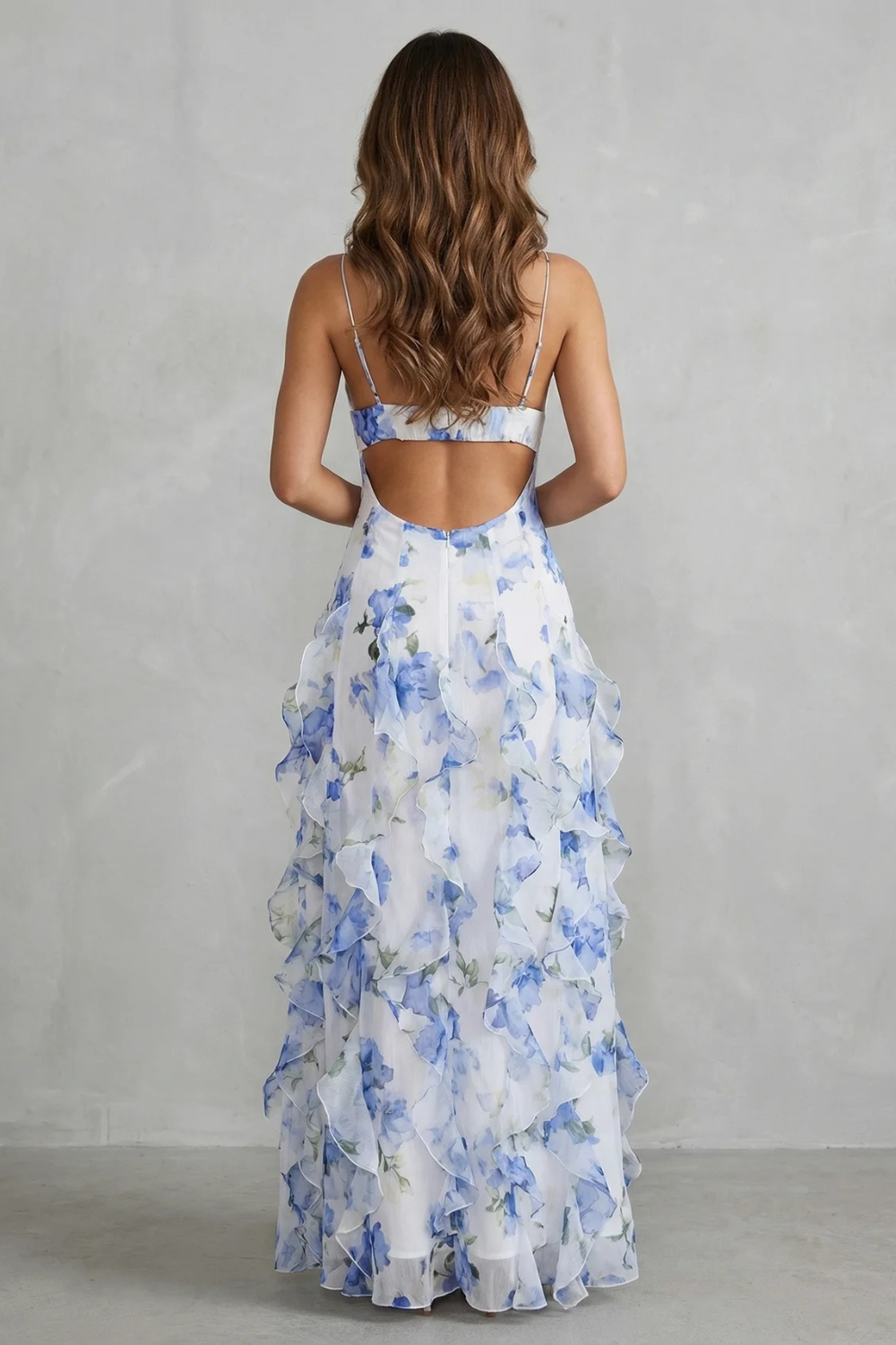 Back view of light blue floral chiffon maxi dress with ruffled tiers and thin straps
