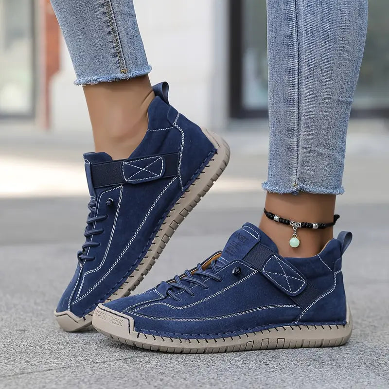 Navy lace-up sneakers with hook-and-loop strap and textured rubber sole