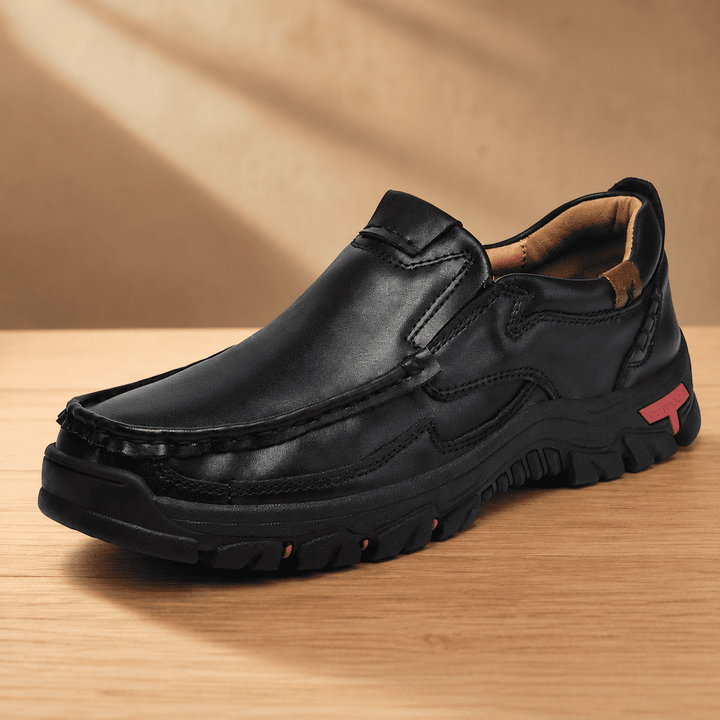 Black slip-on loafer-style shoes with cushioned sole and contrast logo patch