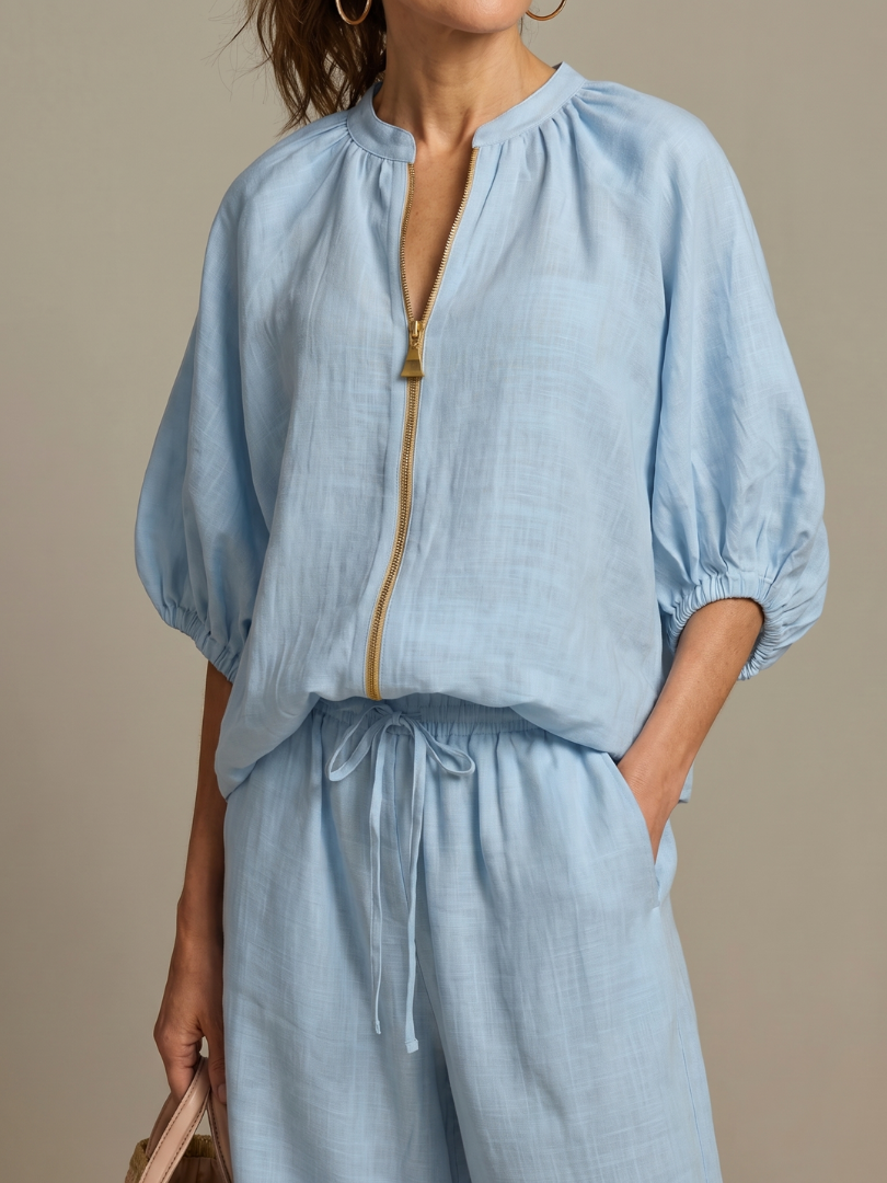 Light blue zip-front blouse with puff sleeves and matching drawstring wide-leg pants