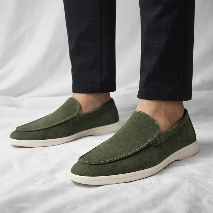 Green suede slip-on loafer with stitched vamp and white rubber sole