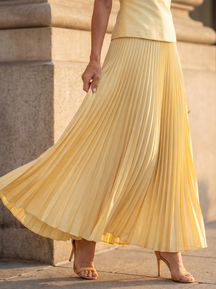 Yellow pleated midi skirt with accordion pleats and flared hem