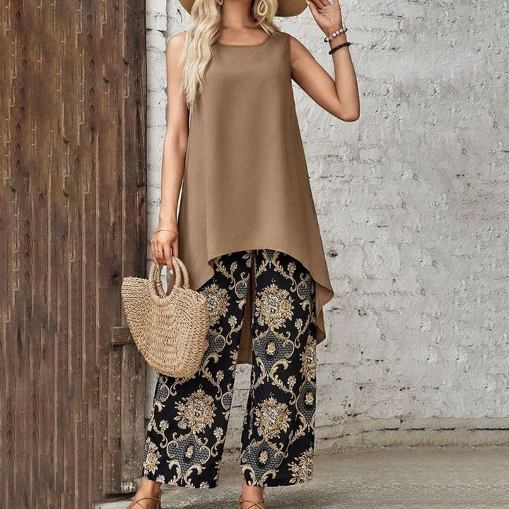Taupe sleeveless tunic with curved hem over black-and-gold ornate patterned wide-leg pants