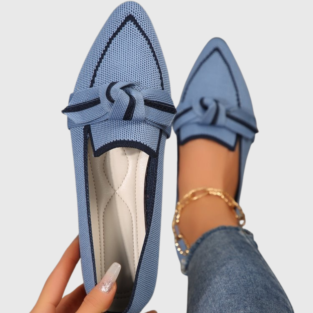 Blue knit loafer shoes with bow-tie strap, flat moccasin style.