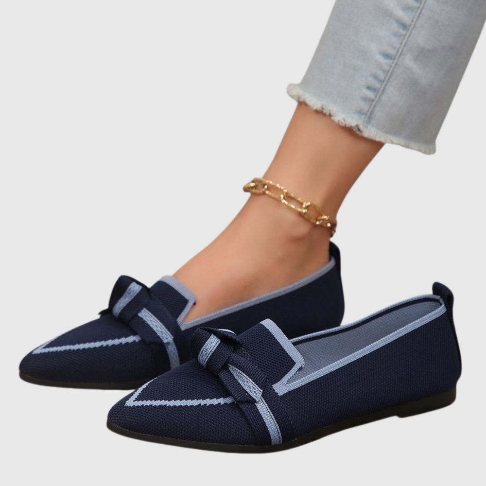 Navy knit loafers with geometric stripe panels and bow strap.