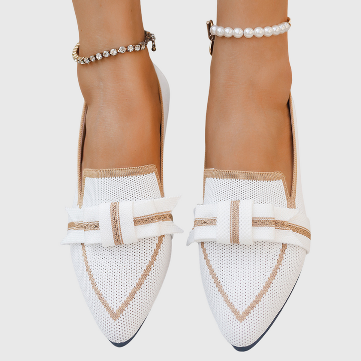 White pointed toe bow flats with brown trim and strap bow