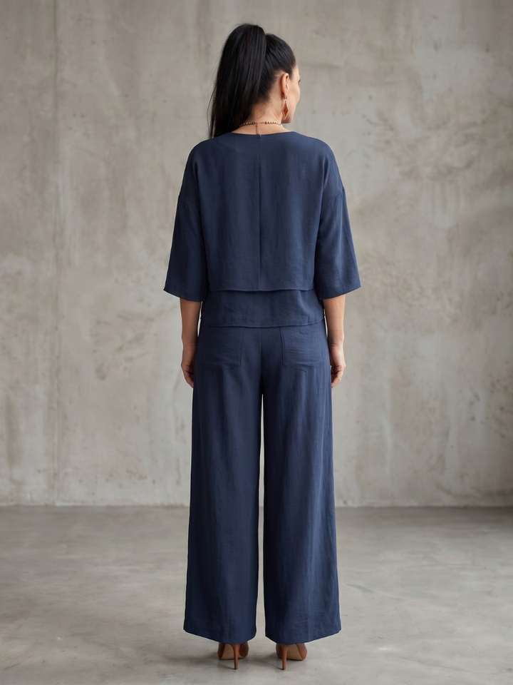 Navy wide-leg pants set with back view of V-neck layered tunic top and wide trousers.
