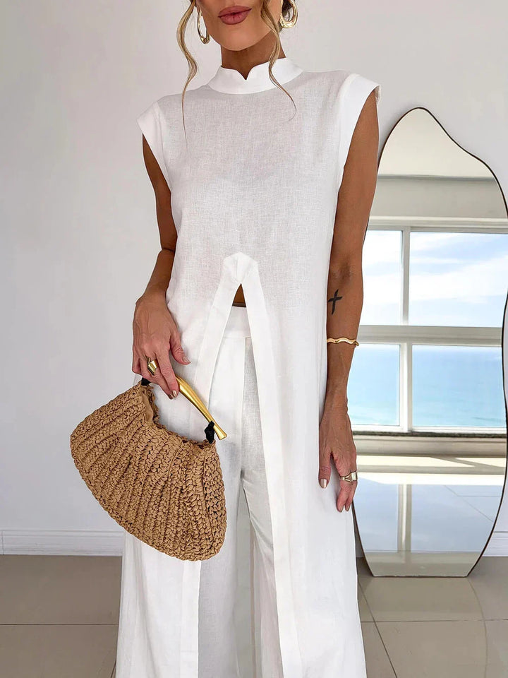 Layered set, white sleeveless high-neck dress with arched front opening; wide-leg pants