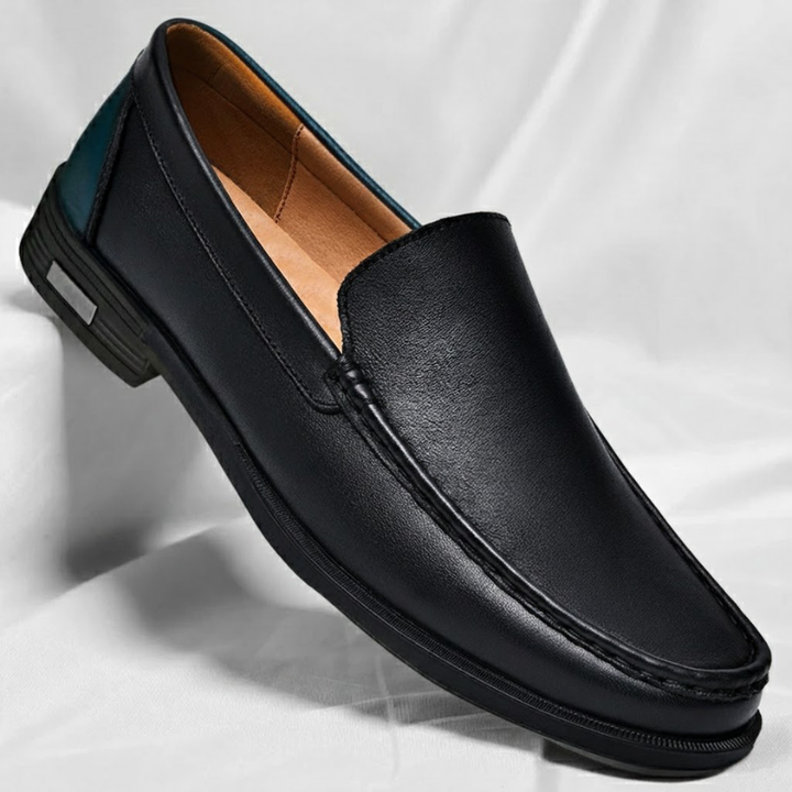Black leather penny loafers with metal bit, contrast stitching, and black rubber sole