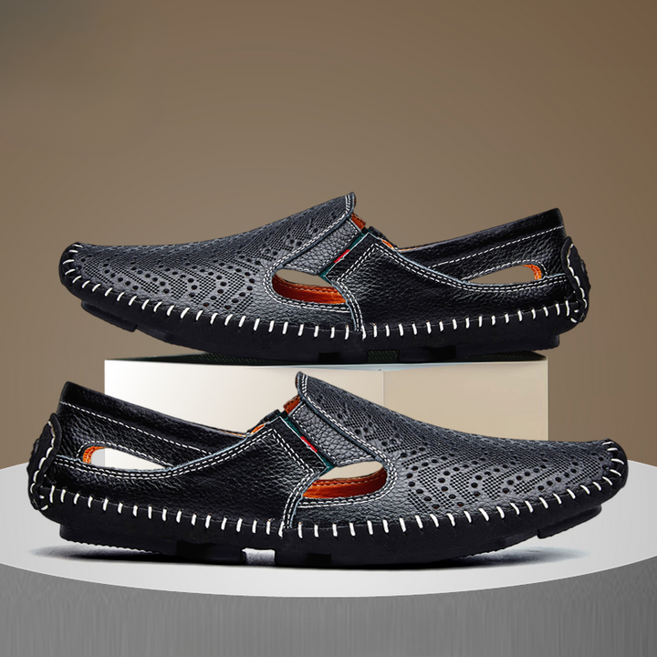 Dark navy slip-on sandals with perforated uppers, orange accents, and stitched rubber sole