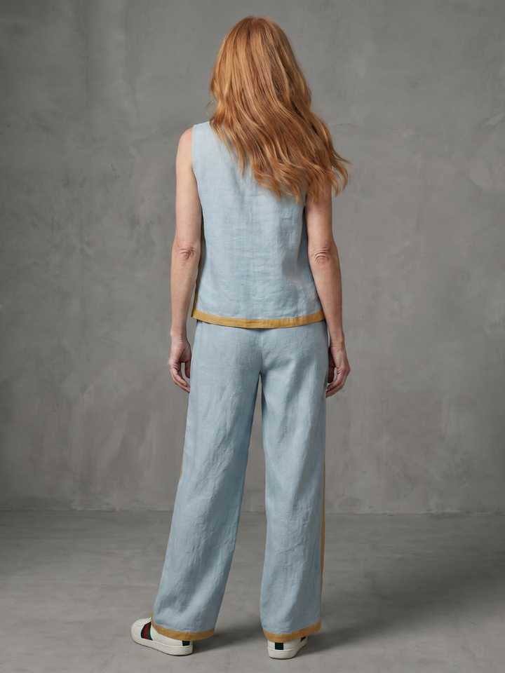 Sky blue linen set with sleeveless back and wide-leg pants, tan contrast trim